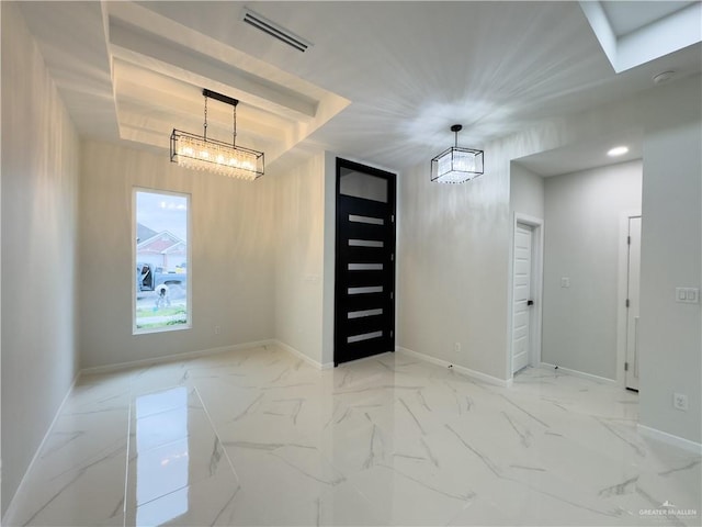 entryway with a chandelier