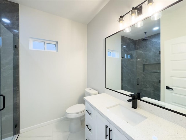 bathroom featuring vanity, a shower with shower door, and toilet