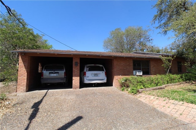 view of front facade with brick siding and gravel driveway