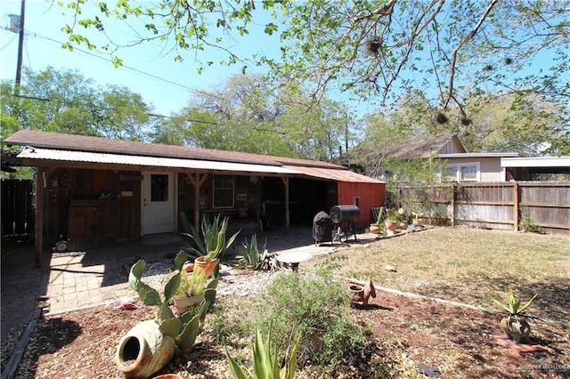 rear view of house featuring fence