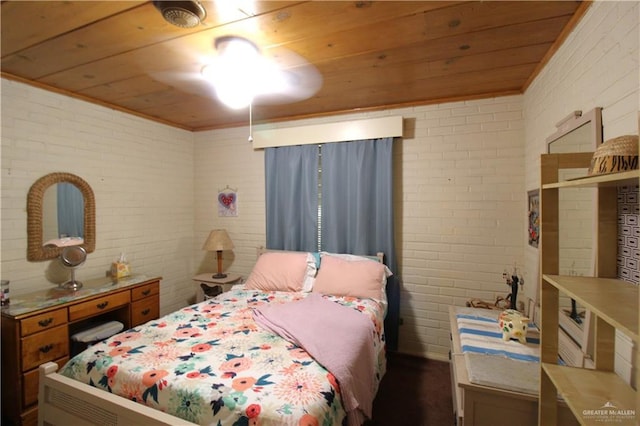 bedroom with wooden ceiling and brick wall