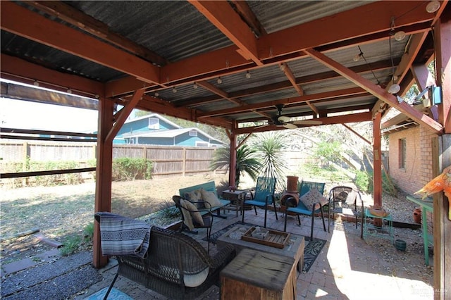 view of patio featuring ceiling fan, fence, and an outdoor hangout area