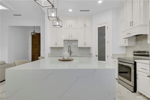 kitchen featuring a center island, hanging light fixtures, light stone countertops, stainless steel electric range oven, and white cabinetry