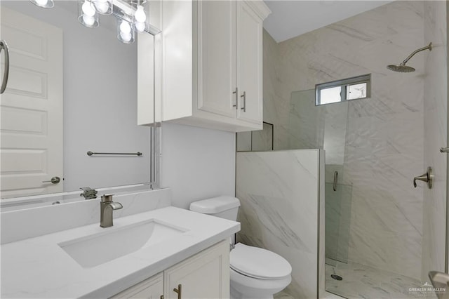 bathroom with vanity, toilet, and a shower with door