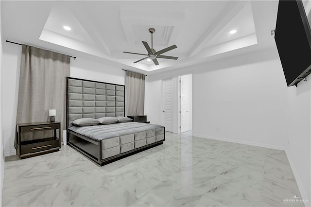 bedroom featuring ceiling fan and a raised ceiling