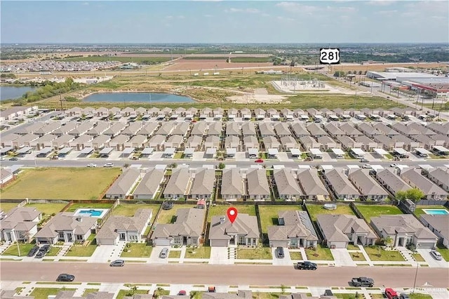 birds eye view of property with a water view