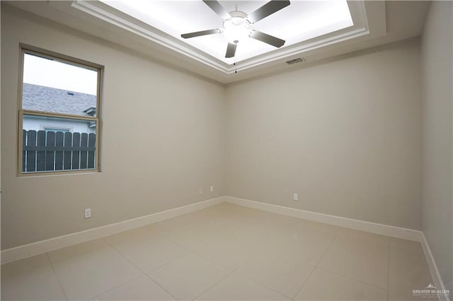 tiled spare room with ceiling fan