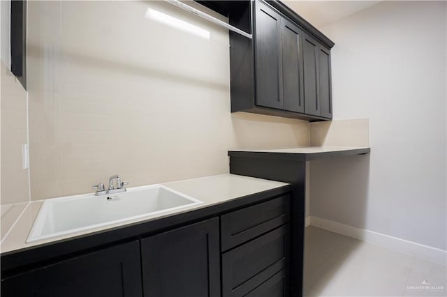 laundry room with light tile patterned floors and sink