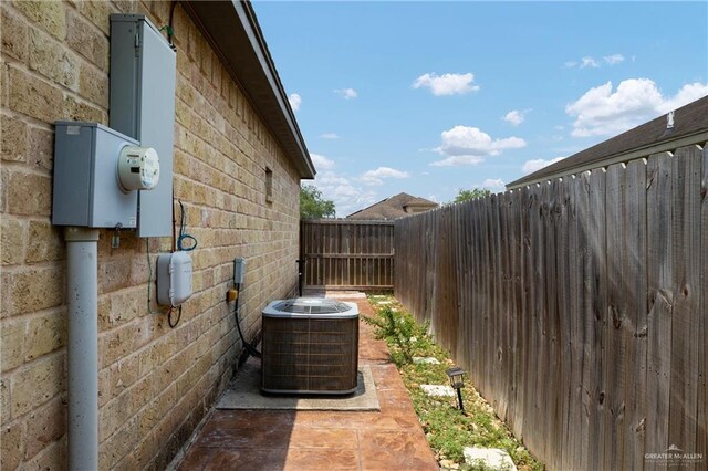 1041 Arroyo Cir, Mercedes, TX 78570 - view of side of property with cooling unit and brick siding