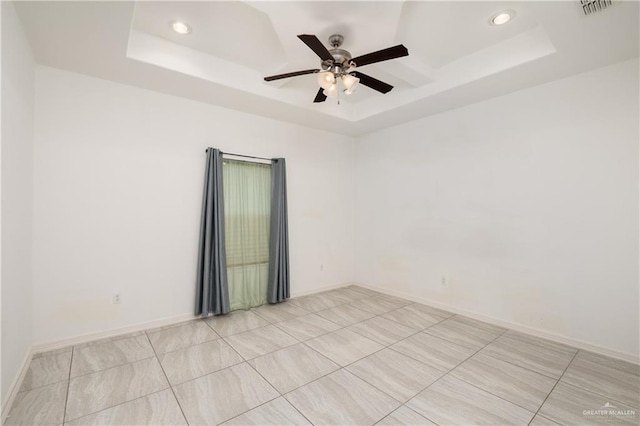 1041 Arroyo Cir, Mercedes, TX 78570 - spare room featuring a raised ceiling, a ceiling fan, recessed lighting, light tile patterned flooring, and baseboards