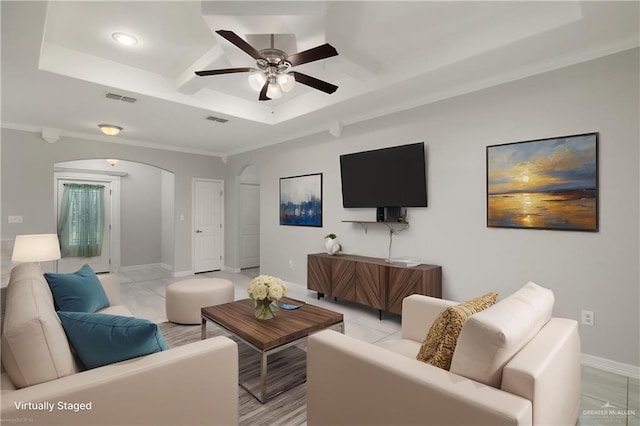 1041 Arroyo Cir, Mercedes, TX 78570 - living room featuring arched walkways, ceiling fan, coffered ceiling, baseboards, and ornamental molding
