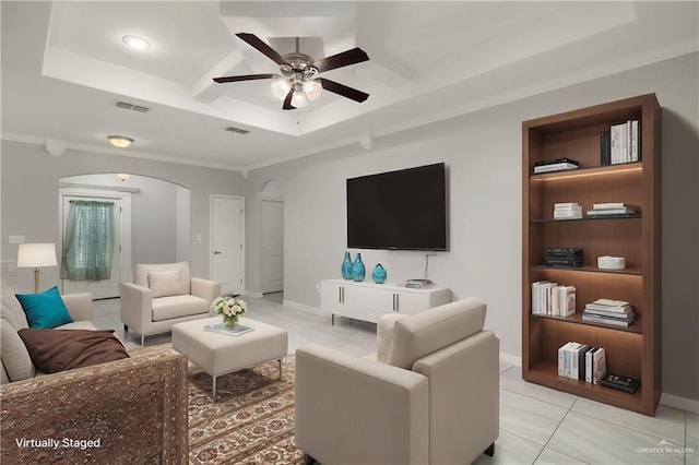 1041 Arroyo Cir, Mercedes, TX 78570 - living room with arched walkways, coffered ceiling, a ceiling fan, light tile patterned floors, and ornamental molding