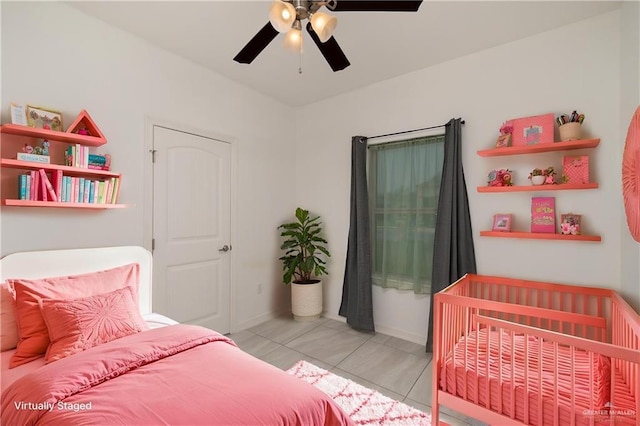 1041 Arroyo Cir, Mercedes, TX 78570 - bedroom featuring light tile patterned floors, ceiling fan, and baseboards