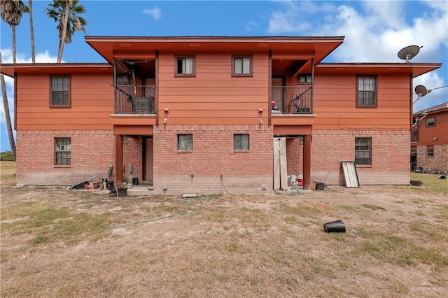 back of property featuring a balcony