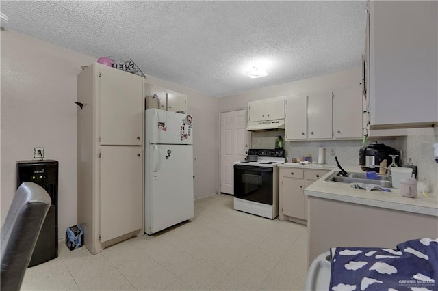 kitchen with a textured ceiling, white appliances, and tasteful backsplash