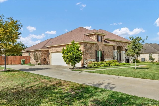 view of front facade featuring a garage and a front lawn