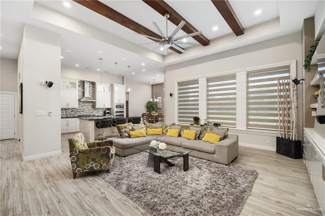 living room featuring light wood-type flooring, ceiling fan, and beam ceiling