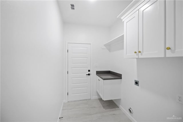 laundry room featuring visible vents, baseboards, marble finish floor, cabinet space, and electric dryer hookup