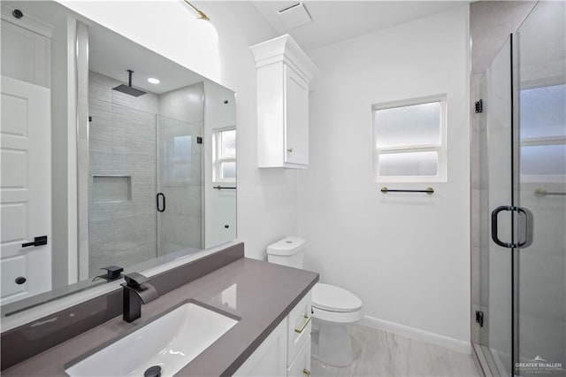 bathroom featuring toilet, marble finish floor, a shower stall, and vanity