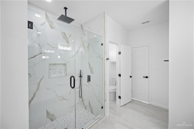 bathroom with marble finish floor, a marble finish shower, visible vents, toilet, and baseboards