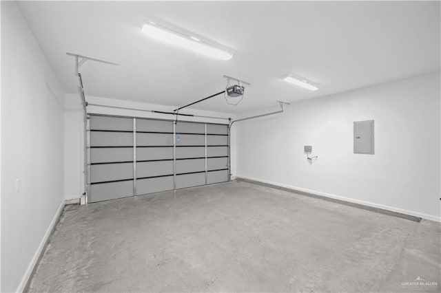 garage with a garage door opener, electric panel, and baseboards