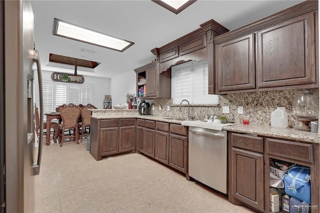 12813 N 106th St, Mission, TX 78573 - kitchen with appliances with stainless steel finishes, open shelves, decorative backsplash, a raised ceiling, and a peninsula