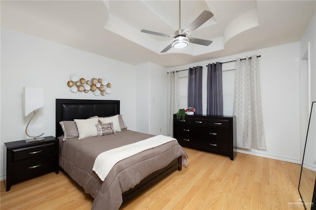 2715 Melanie Dr, Pharr, TX 78577 - bedroom featuring light wood finished floors, a tray ceiling, and a ceiling fan