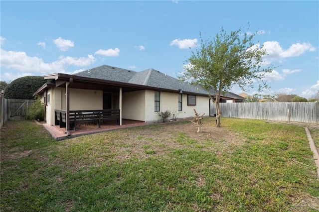 back of property with a patio and a yard