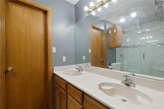 bathroom with vanity, toilet, and walk in shower