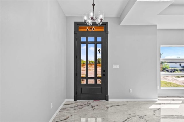 foyer featuring an inviting chandelier