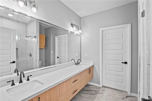 bathroom with vanity, toilet, and a shower with door