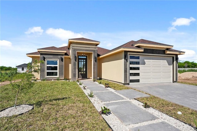 prairie-style home with a front lawn and a garage