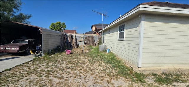 view of side of home with a carport and cooling unit