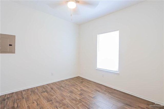 1046 Hidalgo St, Mercedes, TX 78570 - unfurnished room featuring electric panel, wood finished floors, a ceiling fan, and baseboards