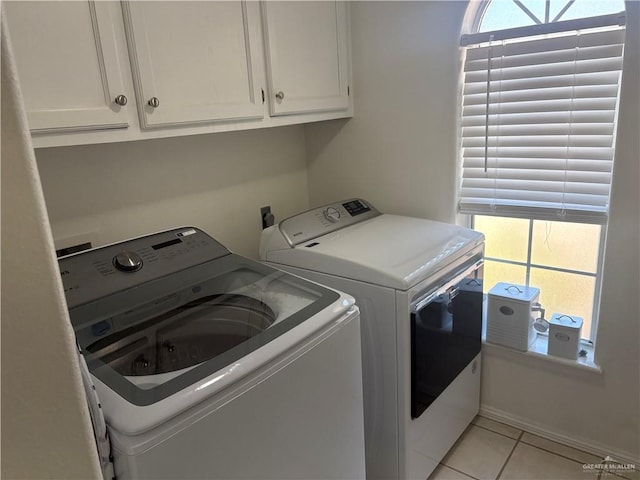 824 Lucy Dr, Alamo, TX 78516 - clothes washing area featuring washer and clothes dryer, cabinet space, and light tile patterned floors