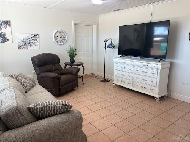 824 Lucy Dr, Alamo, TX 78516 - living room featuring light tile patterned flooring, baseboards, and crown molding