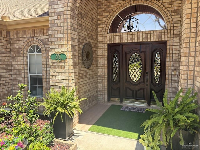 824 Lucy Dr, Alamo, TX 78516 - doorway to property with brick siding and a shingled roof