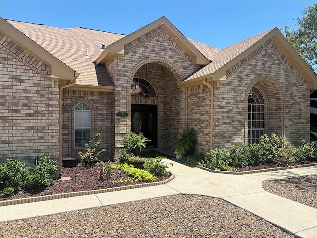 824 Lucy Dr, Alamo, TX 78516 - view of front facade featuring brick siding and roof with shingles