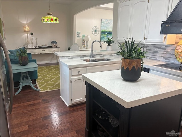 824 Lucy Dr, Alamo, TX 78516 - kitchen with a sink, extractor fan, black electric cooktop, light countertops, and white cabinets