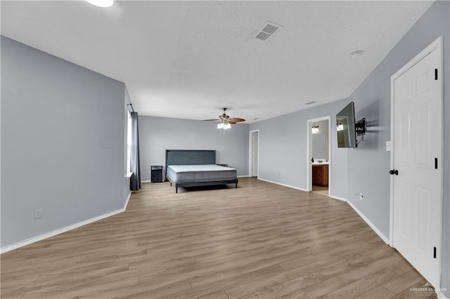 5801 N 36th St, Mcallen, TX 78504 - living area with ceiling fan, light wood-style flooring, baseboards, and a textured ceiling