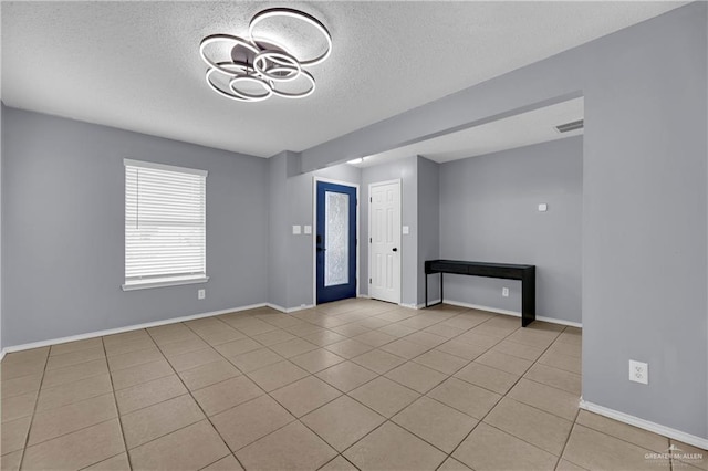 5801 N 36th St, Mcallen, TX 78504 - entrance foyer featuring a textured ceiling, light tile patterned flooring, ceiling fan, and baseboards