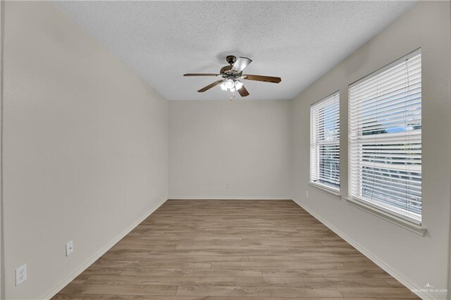 5801 N 36th St, Mcallen, TX 78504 - spare room featuring ceiling fan, a textured ceiling, light wood-style flooring, and baseboards