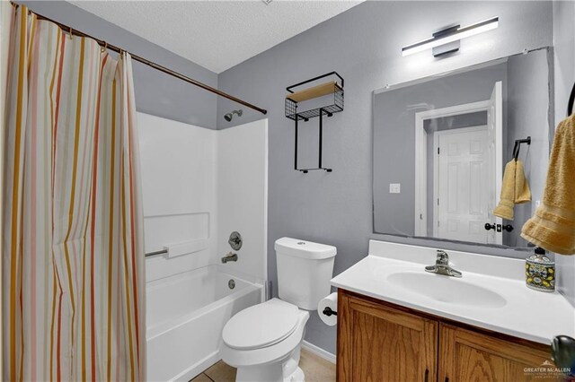 5801 N 36th St, Mcallen, TX 78504 - bathroom featuring vanity, toilet, shower / bath combo with shower curtain, and a textured ceiling