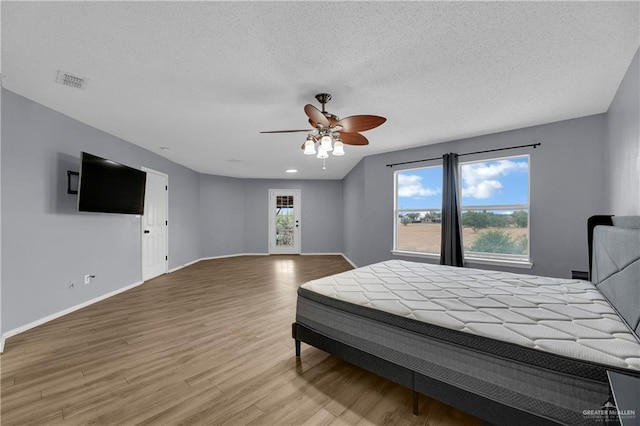 5801 N 36th St, Mcallen, TX 78504 - bedroom featuring wood finished floors, baseboards, a textured ceiling, and ceiling fan