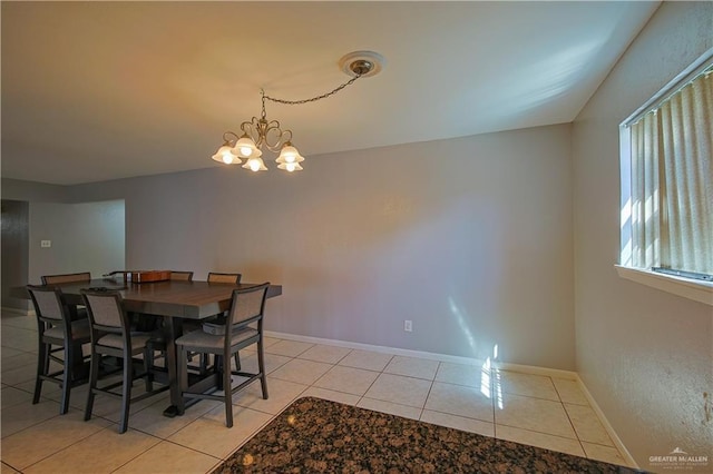 dining space featuring a chandelier and light tile patterned flooring