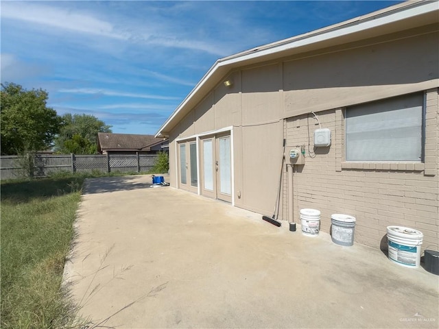 view of property exterior with a patio area