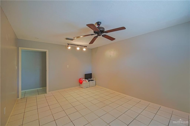 empty room with light tile patterned floors and ceiling fan