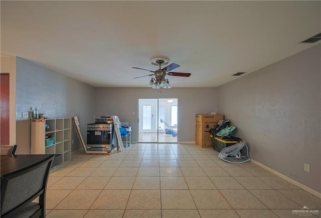 misc room with light tile patterned flooring and ceiling fan