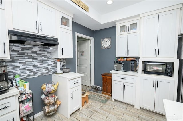 4511 Abbey St, Mercedes, TX 78570 - kitchen with under cabinet range hood, black microwave, light countertops, backsplash, and recessed lighting