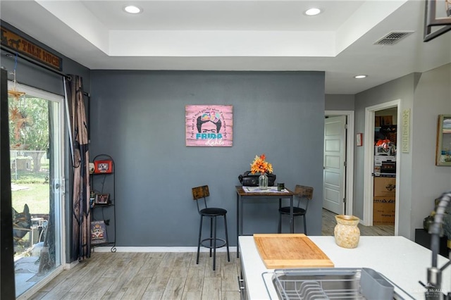 4511 Abbey St, Mercedes, TX 78570 - dining space with a raised ceiling, light wood-style floors, recessed lighting, and baseboards